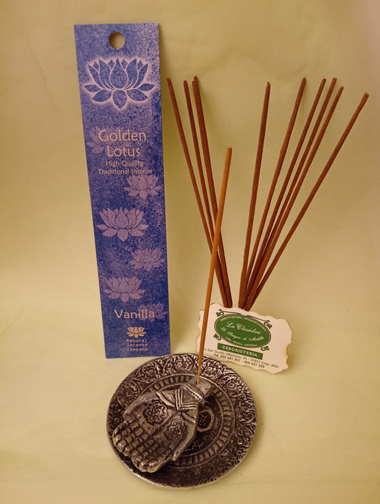 Incenso Vanilla Vaniglia Fiore d'Oriente Linea Golden Lotus, astuccio con mazzetto di bastoncini aperti in piedi, portaincenso in metallo con mano e biglietto da visita esposti da Erboristeria La Clessidra Carpi.